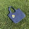 Example input: the seller's phone photo of a blue crochet tote bag on grass